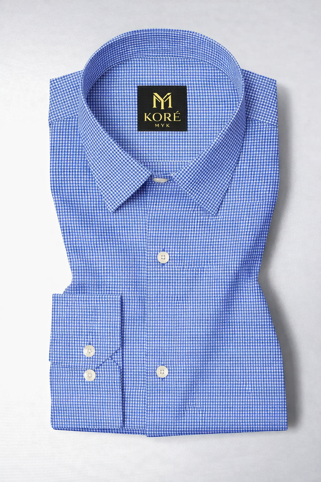 Blue checkered dress shirt with a Kore logo on a light gray background