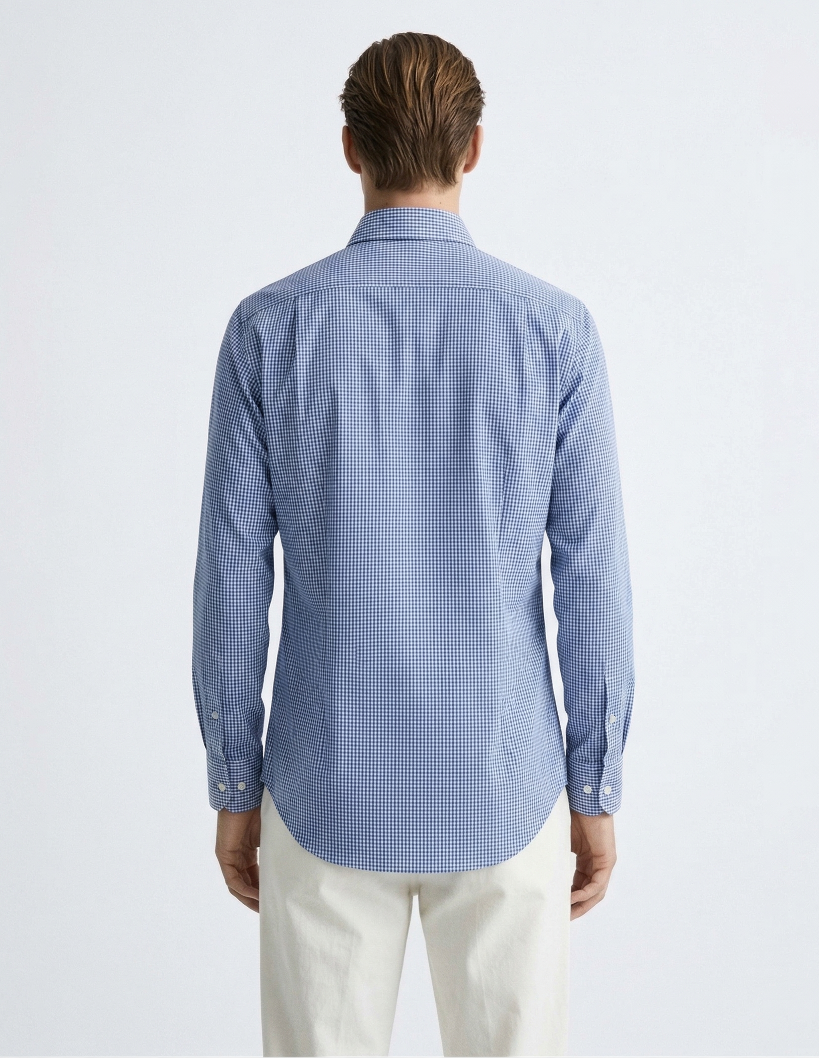 Man wearing a blue checkered shirt on a white background